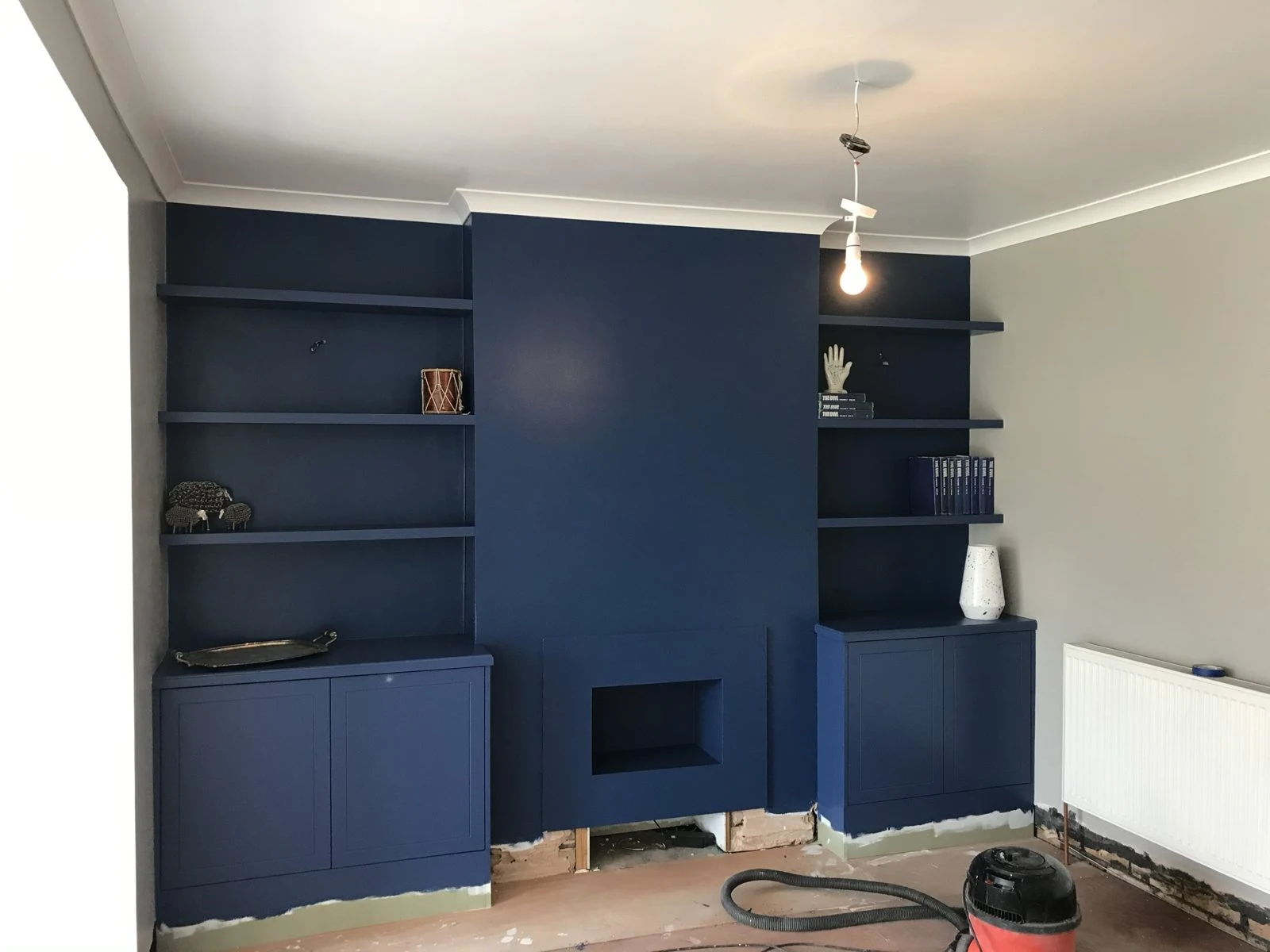 Navy alcove units and shelves before final finishing in Bristol