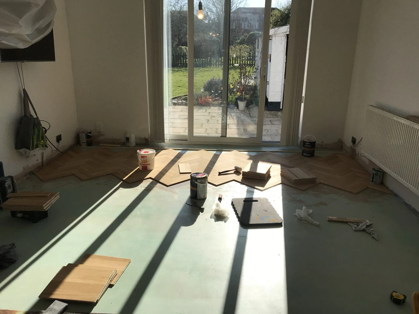 Herringbone parquet being laid by hand in Bristol