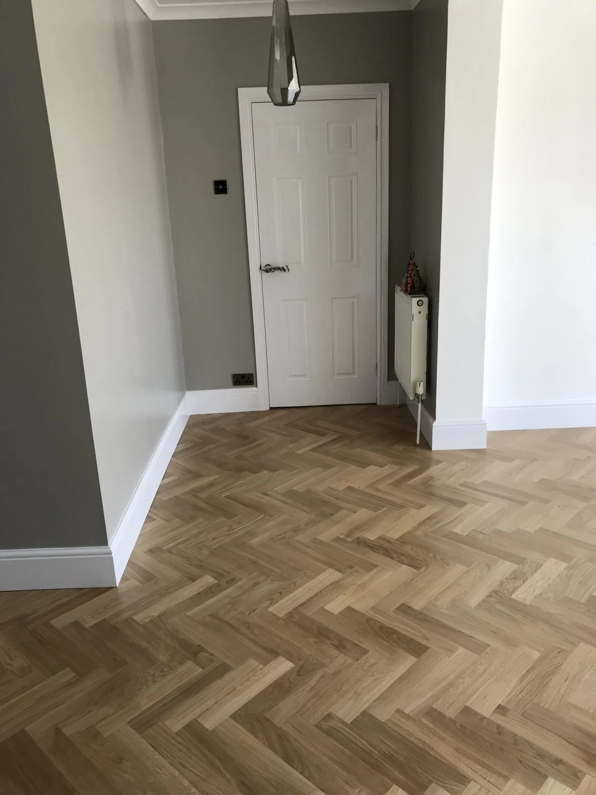 Herringbone oak parquet leading to an internal door in Bristol