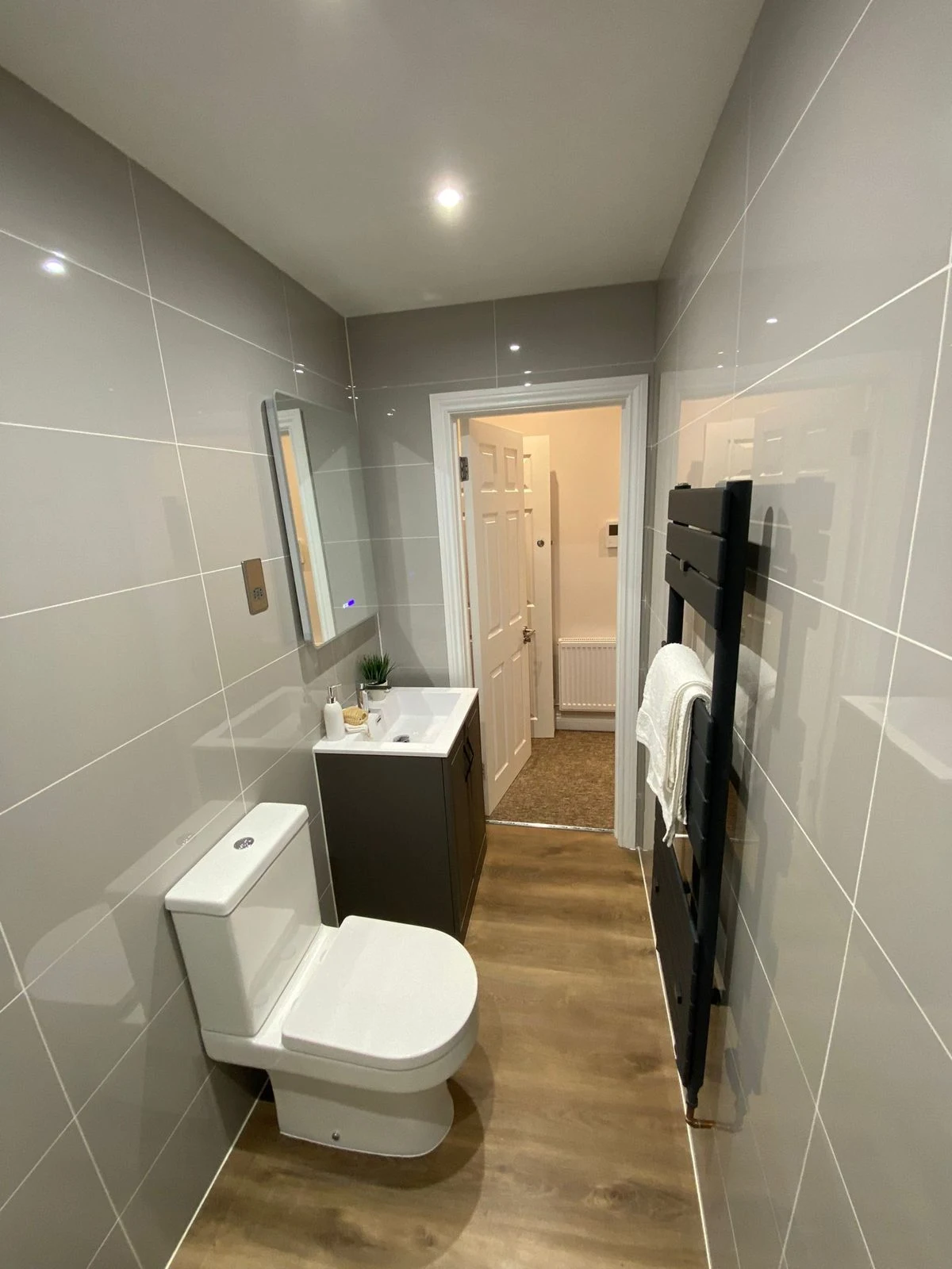 Bathroom with large grey tiles and vanity unit in Bath