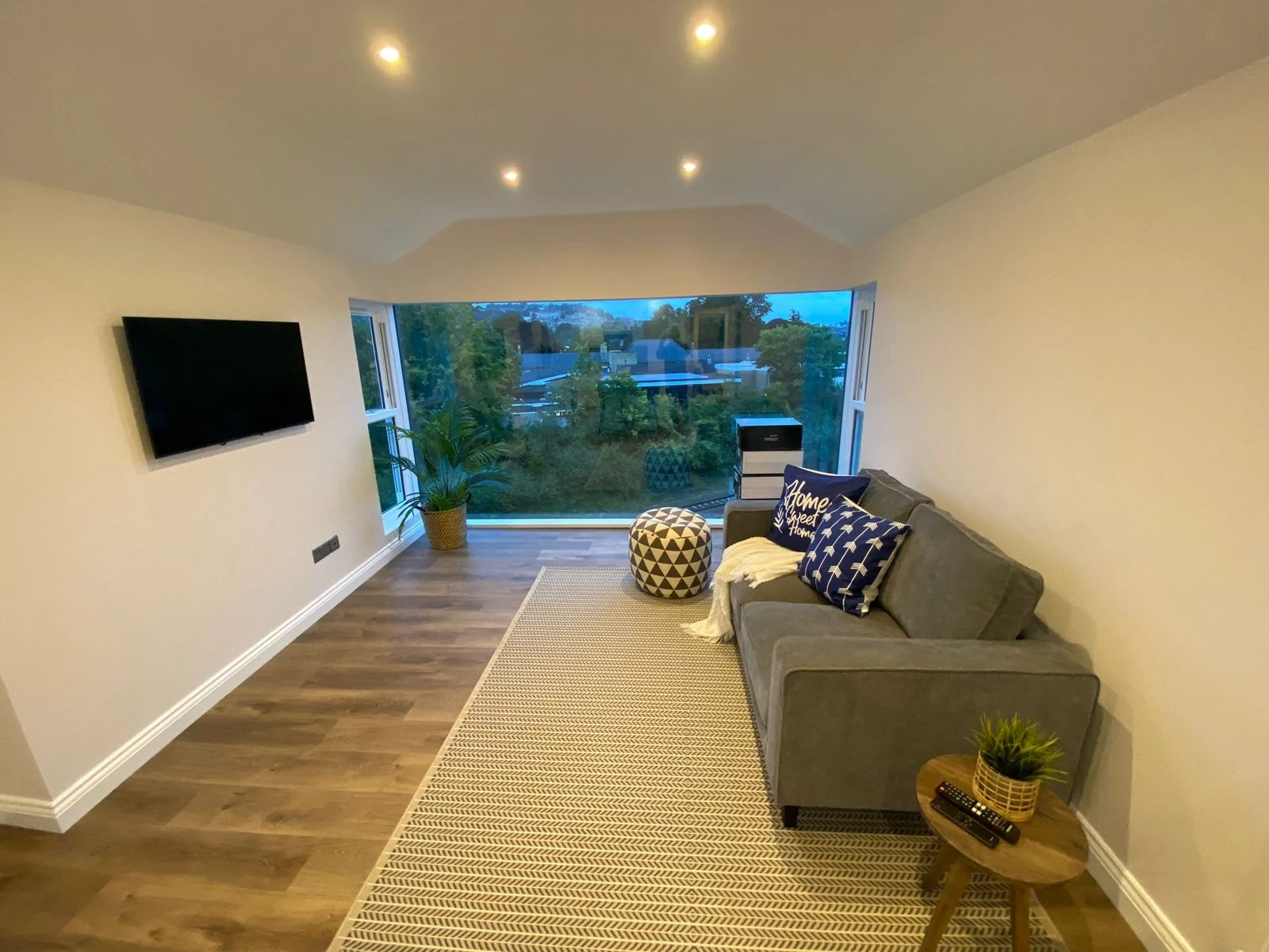 Refurbished flat living room with panoramic window and wood-effect flooring in Bath