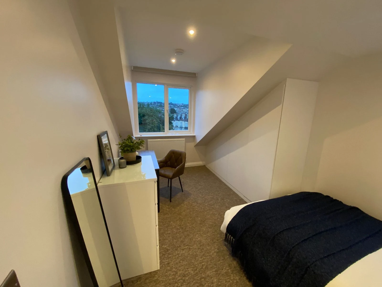 Loft bedroom with eaves storage in Bath