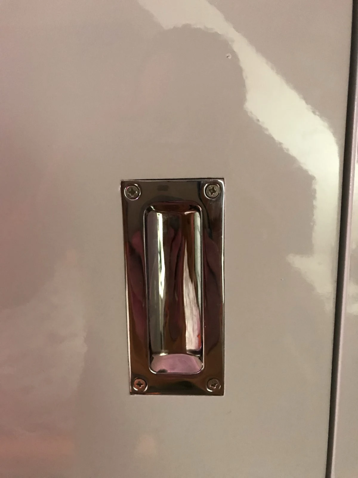 Polished chrome recessed handle on a gloss wardrobe door