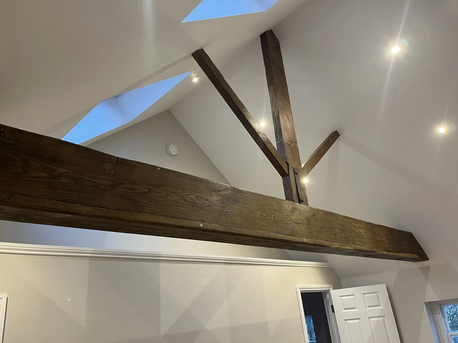 Renovated loft with restored oak beam, roof windows and LED downlights