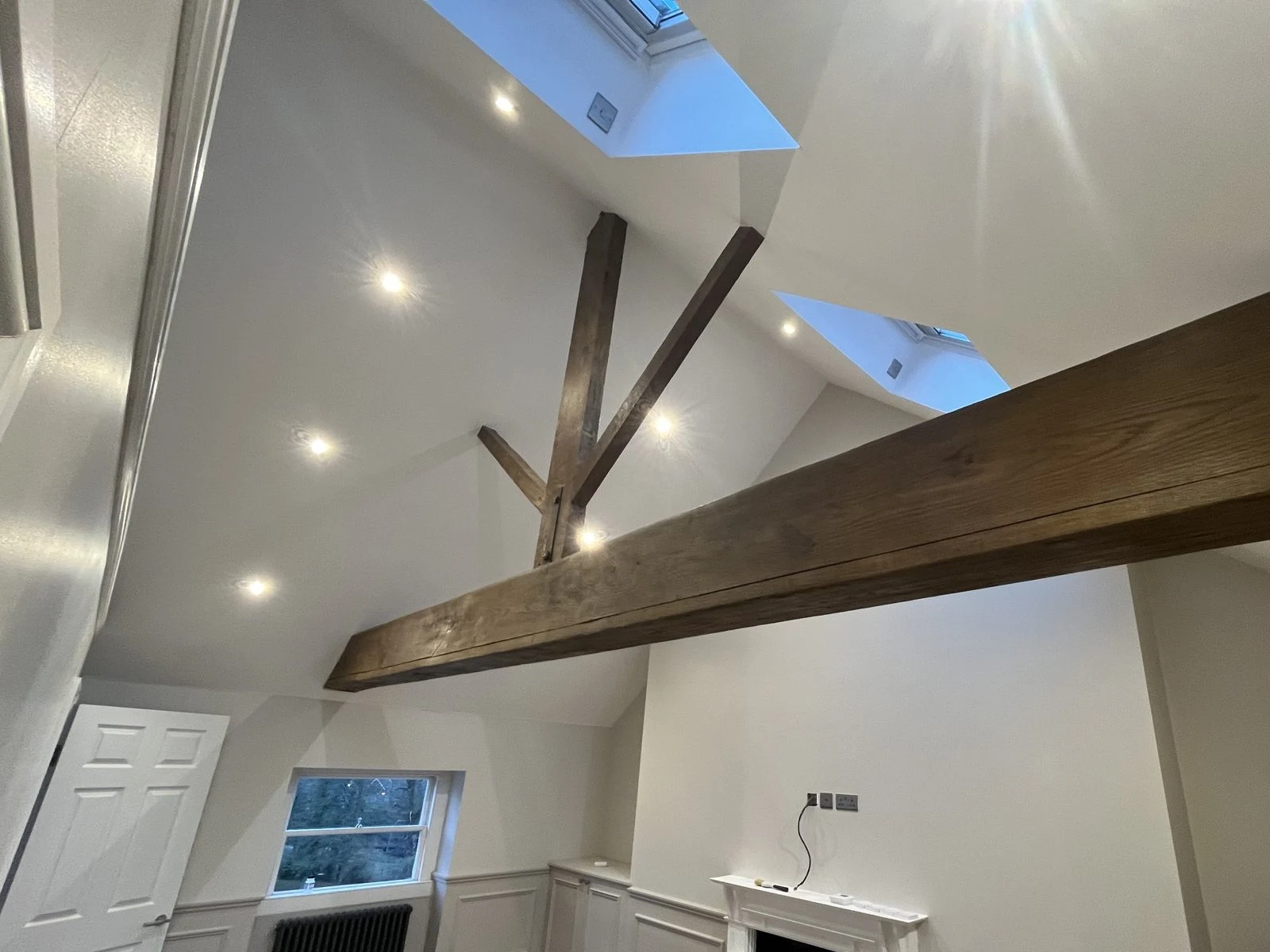 Finished loft room with roof windows, panelling and restored oak beam